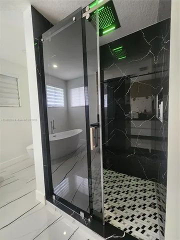 a bathroom with a glass door shower