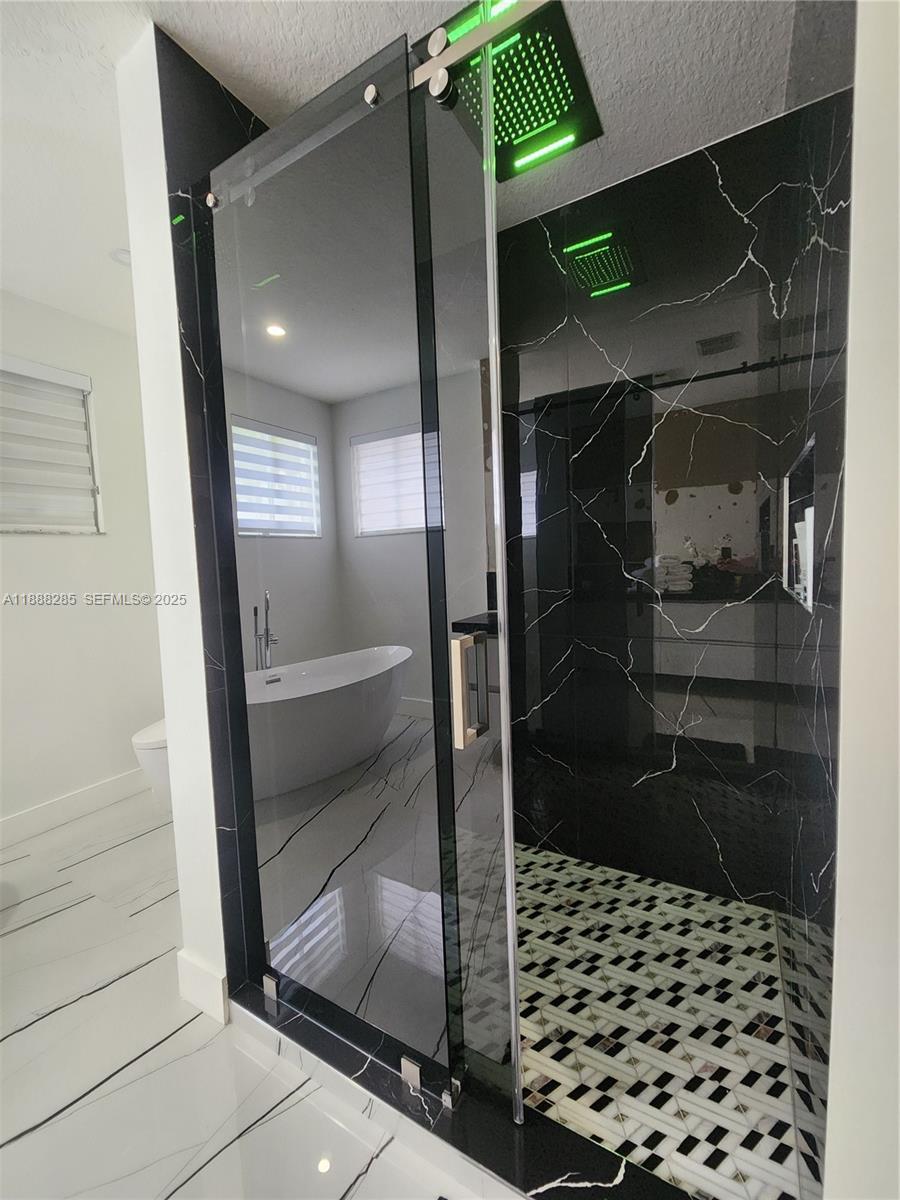 16411 Southwest 60th Terrace Miami, FL 33193 - Photo 16 of 37 a bathroom with a glass door shower