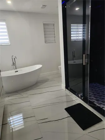 a bathroom with a bathtub and shower