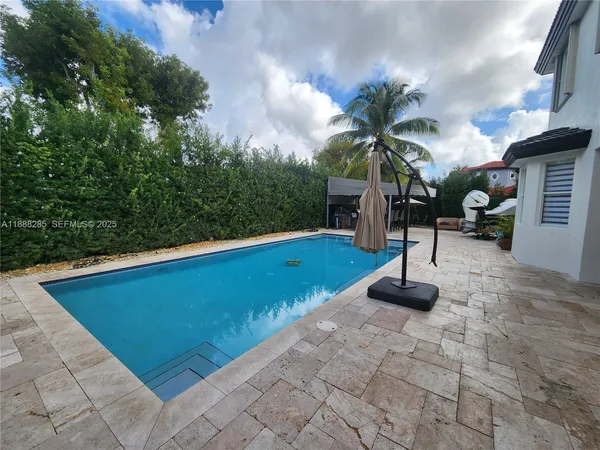 an aerial view of a house with garden space and street view