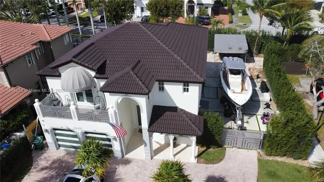 an aerial view of a house with a swimming pool