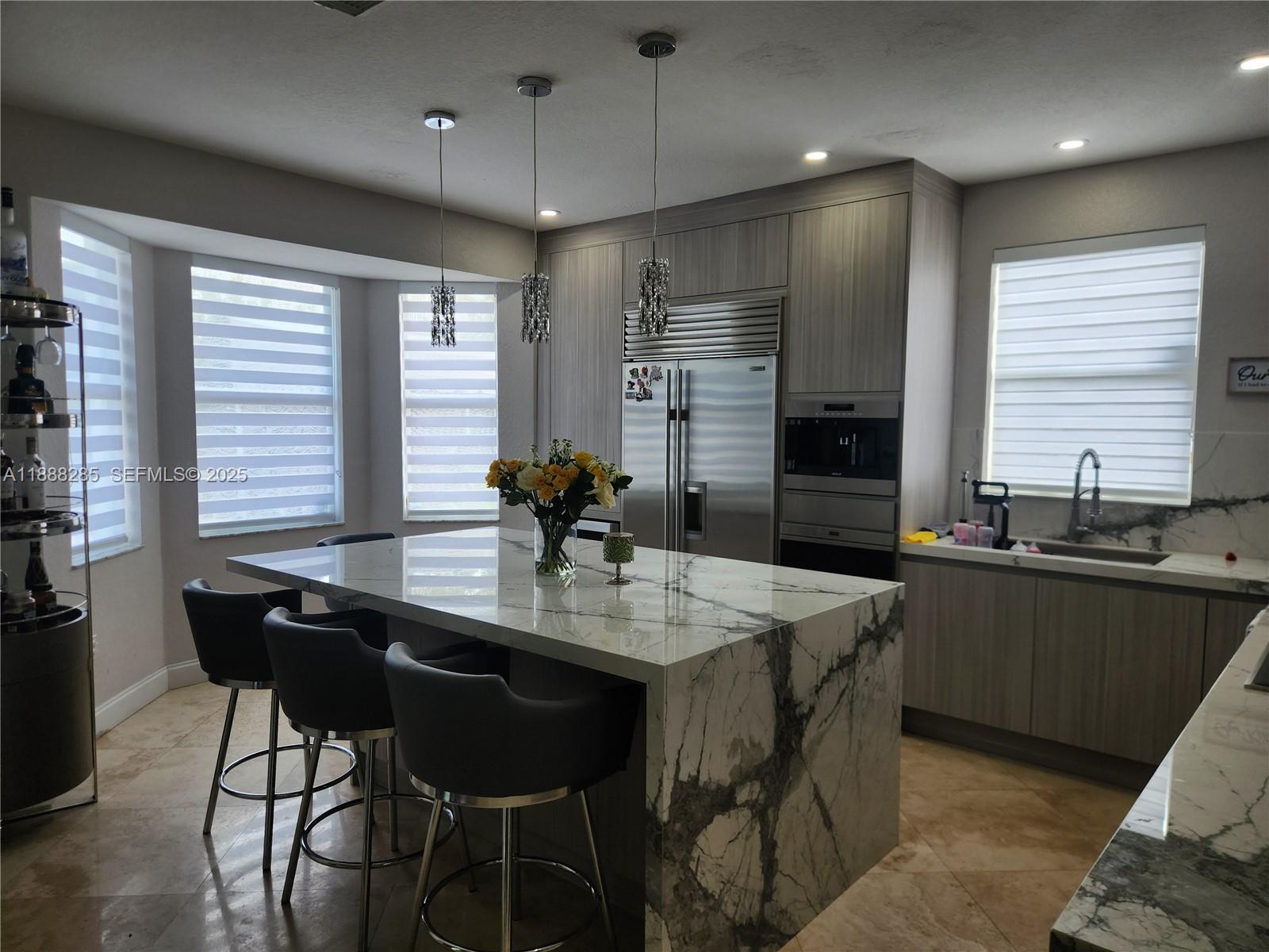 16411 Southwest 60th Terrace Miami, FL 33193 - Photo 5 of 37 a kitchen with granite countertop a sink counter space and dining table in it