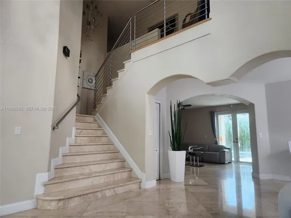 a view of entryway and bedroom with wooden floor