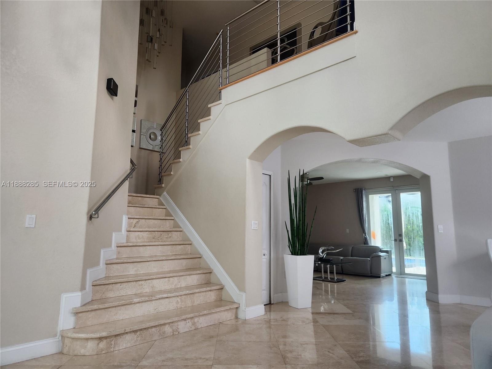 16411 Southwest 60th Terrace Miami, FL 33193 - Photo 6 of 37 a view of entryway and bedroom with wooden floor