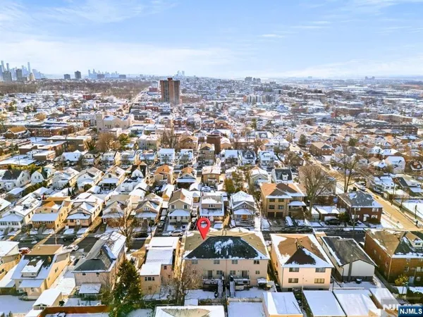 an aerial view of residential houses with city view