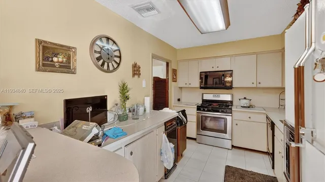 a kitchen with a stove and a refrigerator