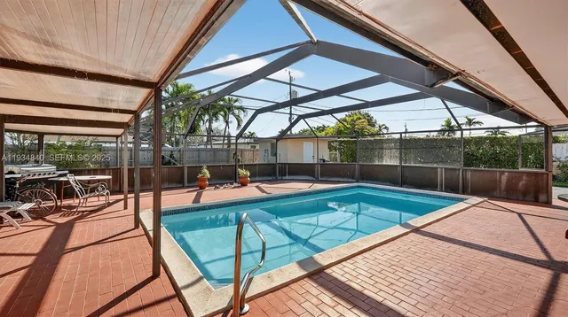 a view of a backyard with a swimming pool