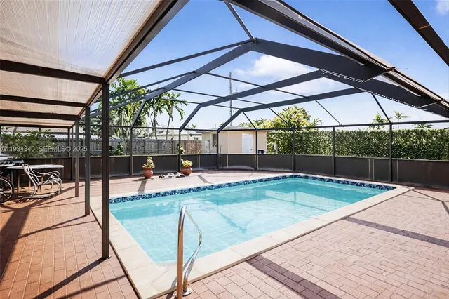 a view of a house with swimming pool and sitting area