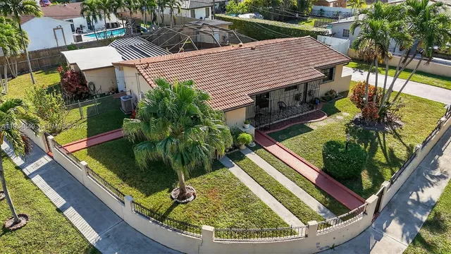 an aerial view of a house with a swimming pool yard and outdoor seating