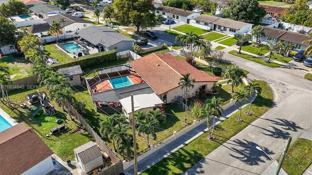 an aerial view of multiple houses with yard