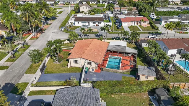 an aerial view of a house with swimming pool garden and patio