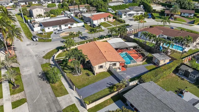 an aerial view of a house with garden space and sitting area