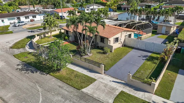 an aerial view of a house with a yard