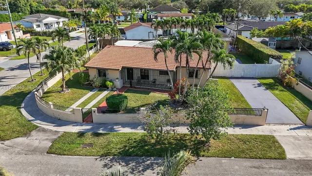an aerial view of multiple houses with yard