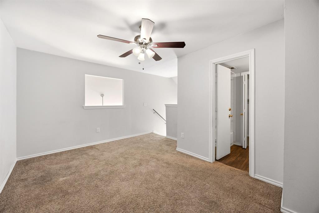 9837 Walnut Street, Unit S203 Dallas, TX 75243 - Photo 20 of 26 This room features plush brown carpet, neutral grey walls, and a ceiling fan with integrated lighting