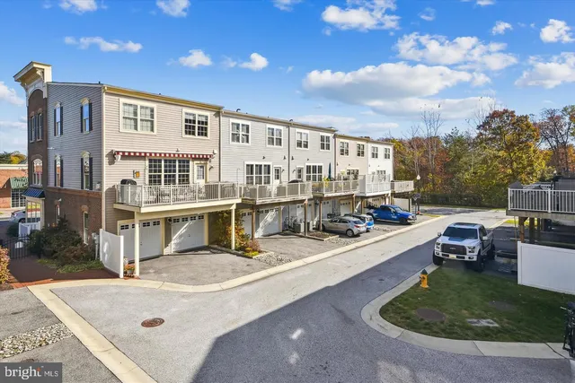 a view of a patio with couches table and chairs with potted plants and big yard