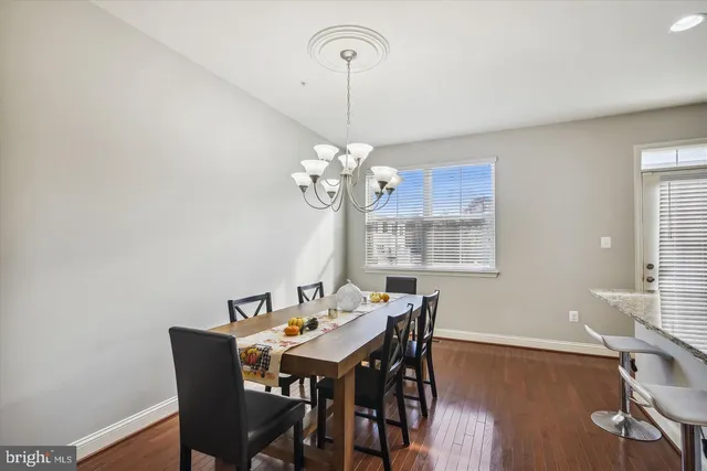 a view of a dining room with a table and chairs