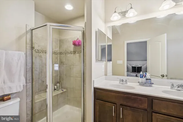 a bathroom with a shower sink and a mirror