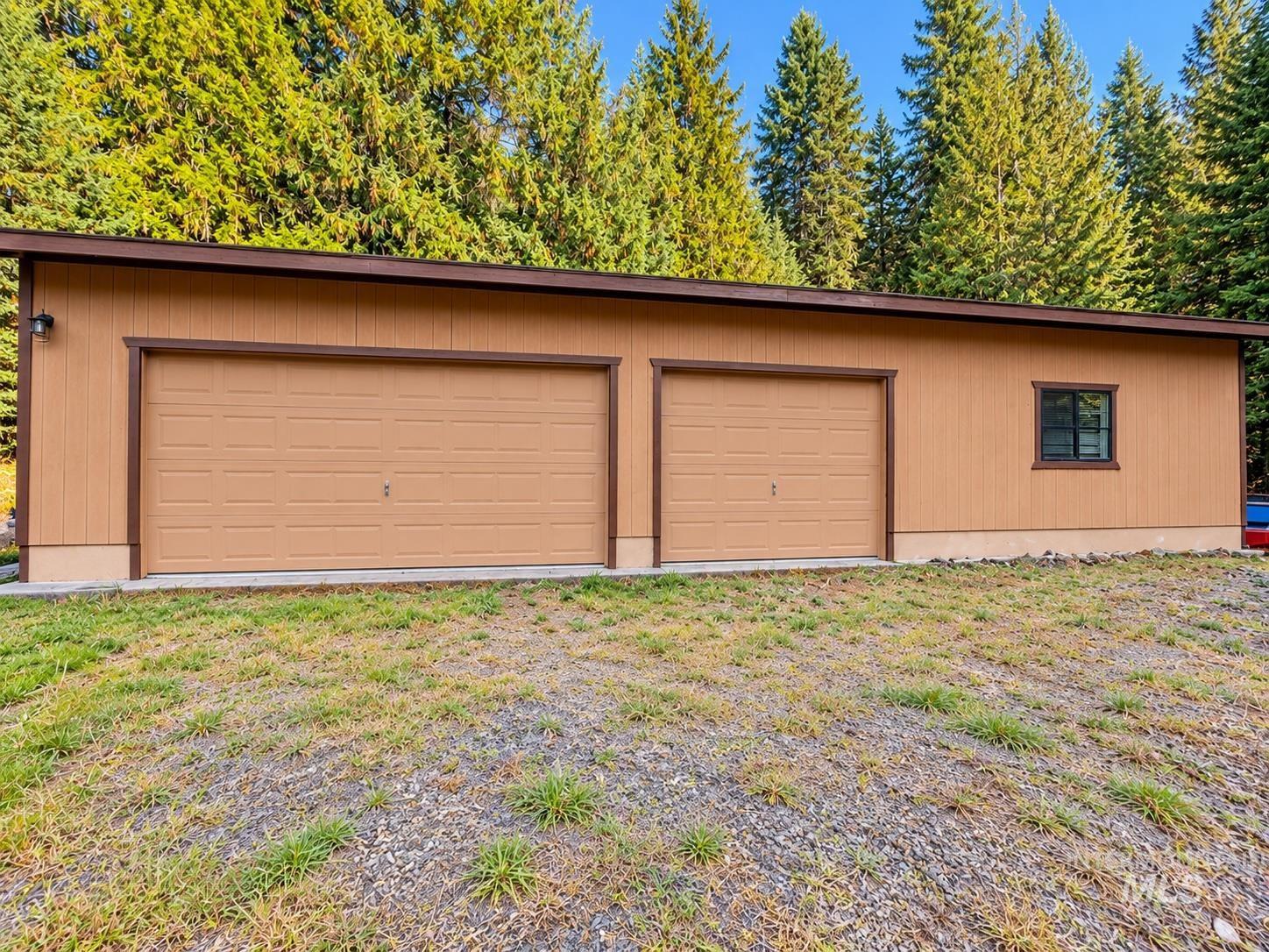 687 Big Cedar Road Kooskia, ID 83539 - Photo 2 of 37 Two-car garage with a single window and exterior lighting