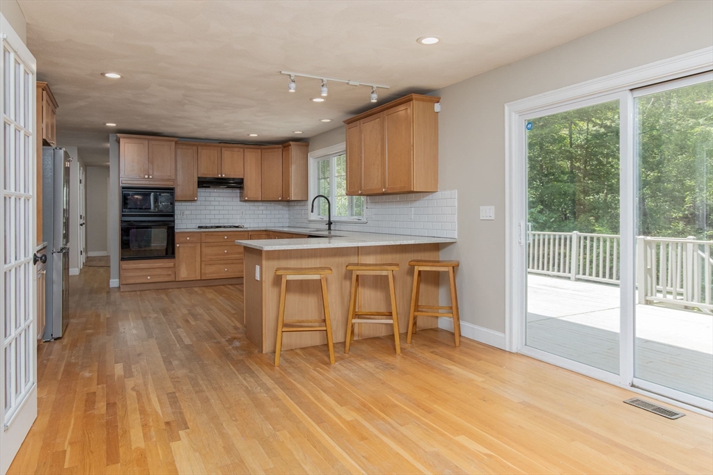 3 Integrity Way Groton, MA 01450 - Photo 8 of 42 a kitchen with kitchen island a large counter top space a sink stainless steel appliances and cabinets