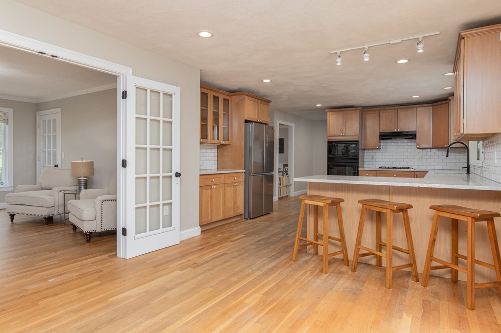 3 Integrity Way Groton, MA 01450 - Photo 9 of 42 a kitchen with stainless steel appliances a refrigerator and wooden floor