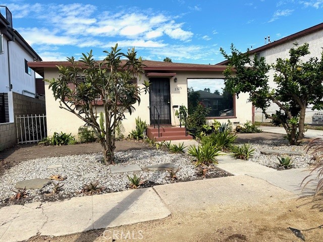 a view of a house with potted plants in front of it
