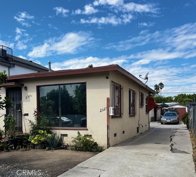 2323 Carmona Avenue Los Angeles, CA 90016 - Photo 2 of 5 a view of a car park in front of house