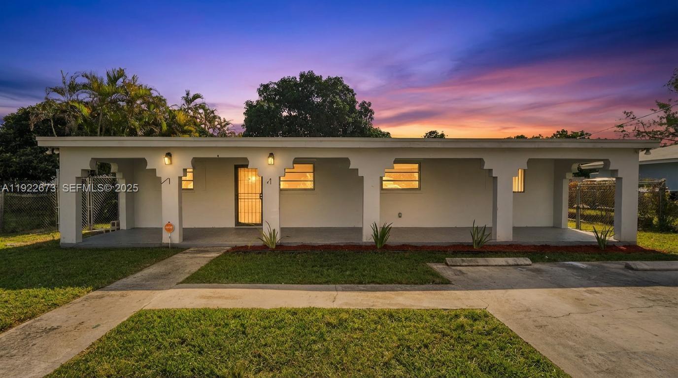 10220 Southwest 178th Street, Unit 10220 Miami, FL 33157 - Photo 1 of 25 a front view of a house with a yard