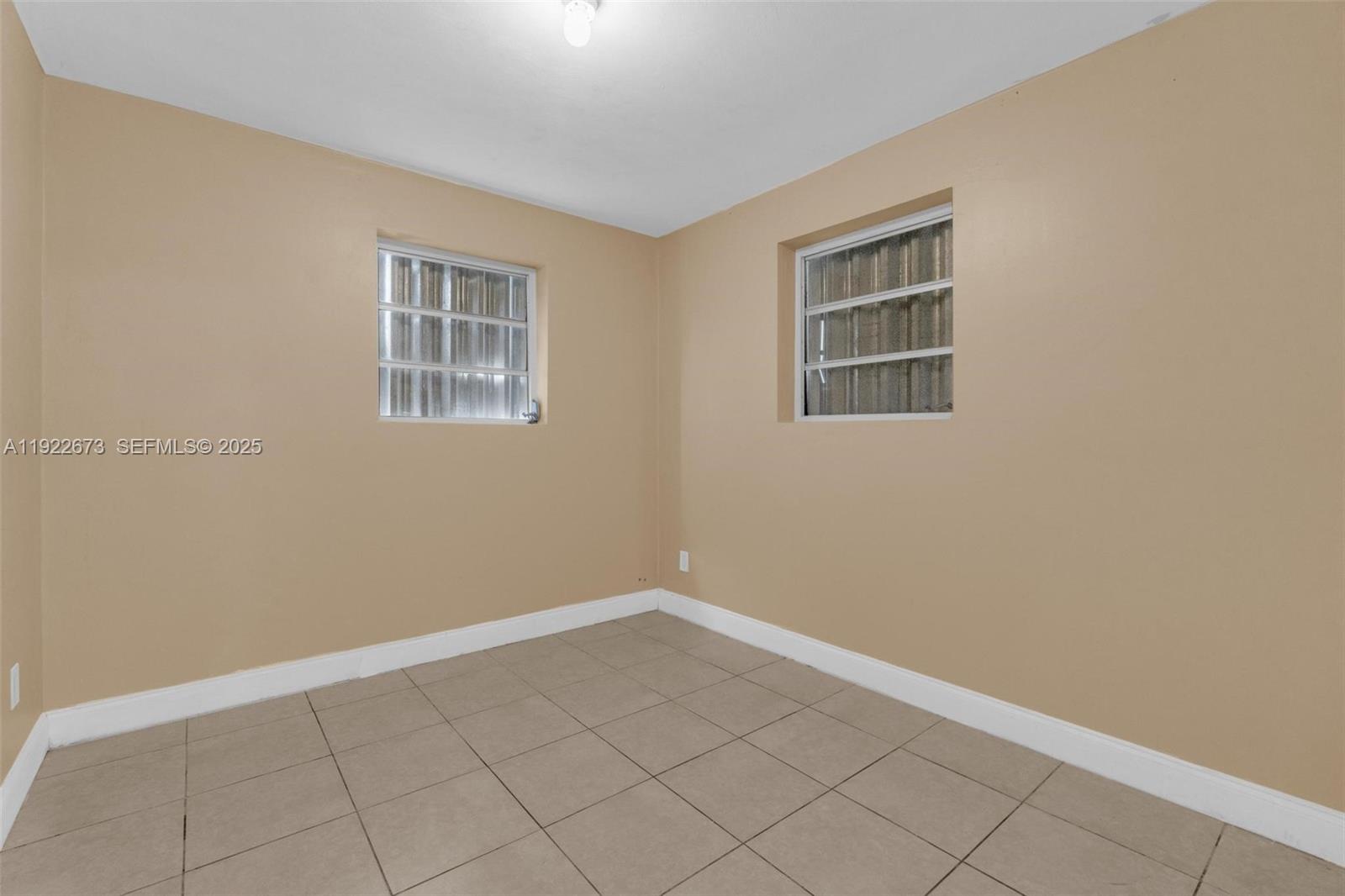 10220 Southwest 178th Street, Unit 10220 Miami, FL 33157 - Photo 12 of 25 a view of an empty room with a window