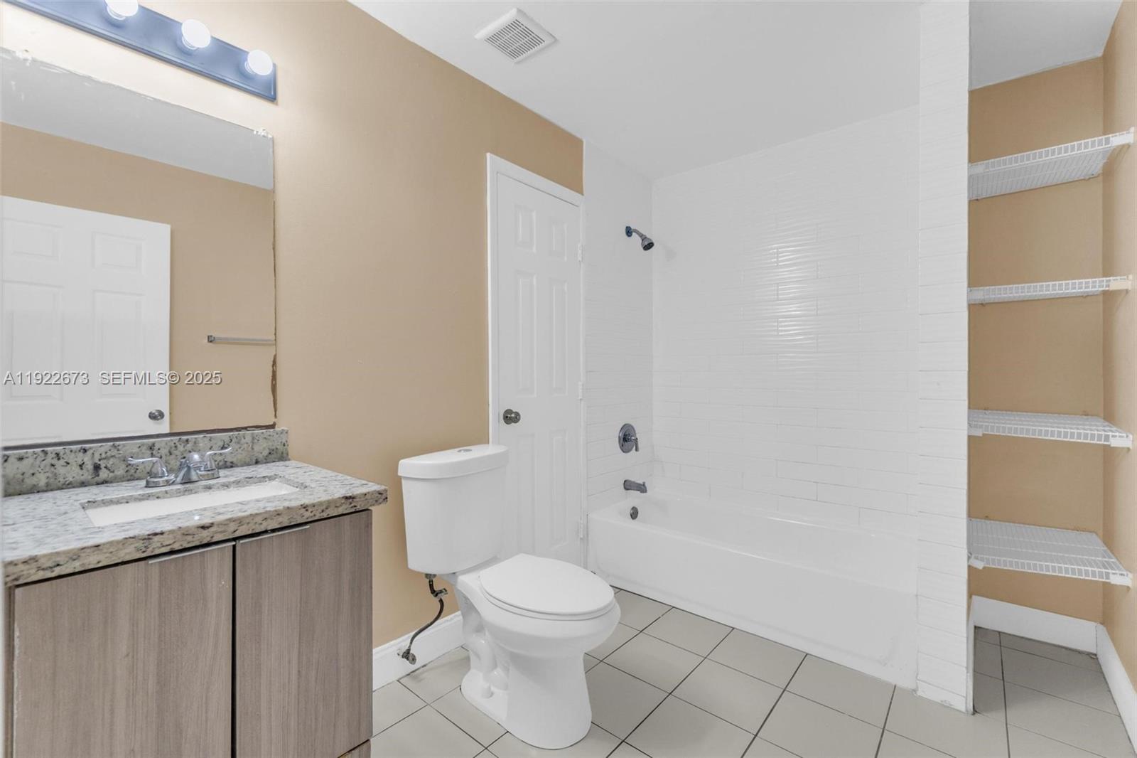 10220 Southwest 178th Street, Unit 10220 Miami, FL 33157 - Photo 14 of 25 a bathroom with a granite countertop sink a toilet and shower