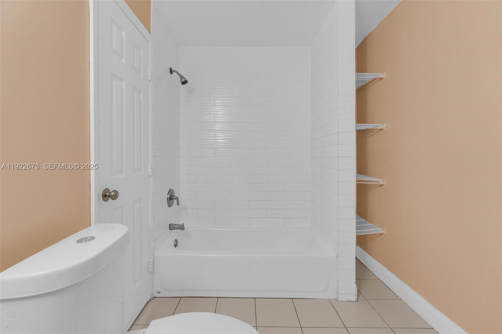 10220 Southwest 178th Street, Unit 10220 Miami, FL 33157 - Photo 15 of 25 a bathroom with a granite countertop bathtub shower and toilet