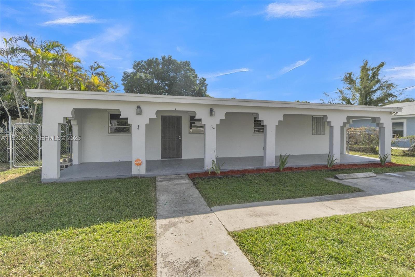 10220 Southwest 178th Street, Unit 10220 Miami, FL 33157 - Photo 2 of 25 front view of a house with a yard