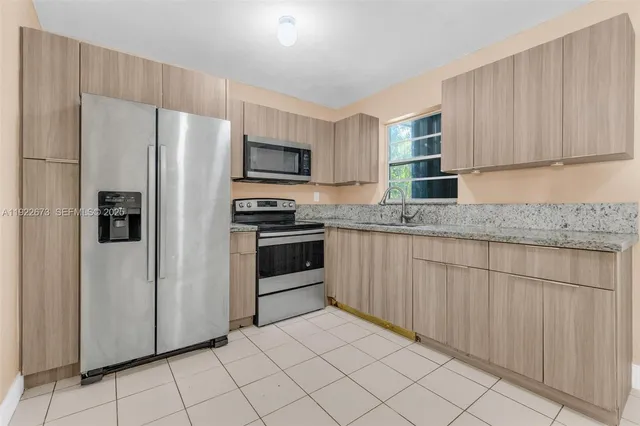 a kitchen with granite countertop cabinets and steel stainless steel appliances