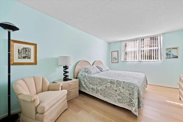 a bedroom with a bed couch and a window