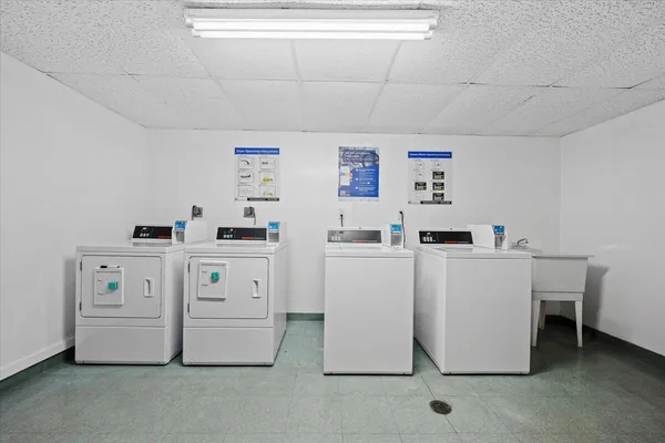 a utility room with cabinets washer and dryer