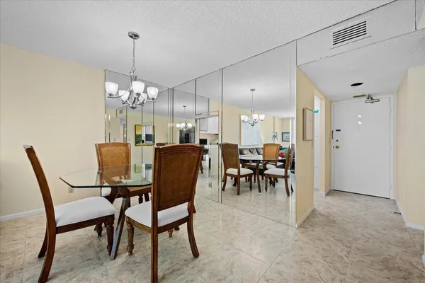 a view of a dining room with furniture and chandelier