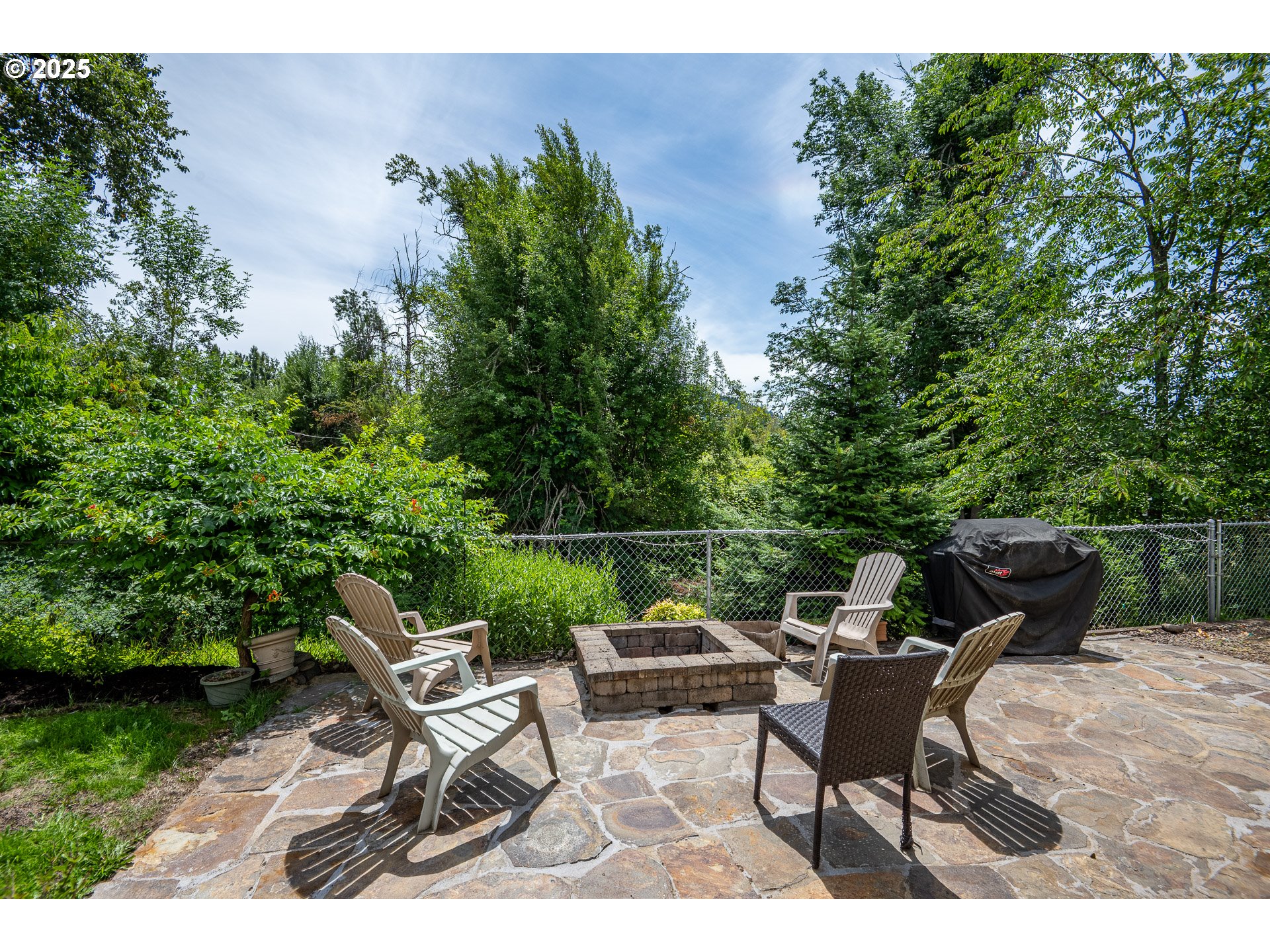 4217 Cole Way Springfield, OR 97478 - Photo 34 of 43 a view of backyard with seating space and trees in the background