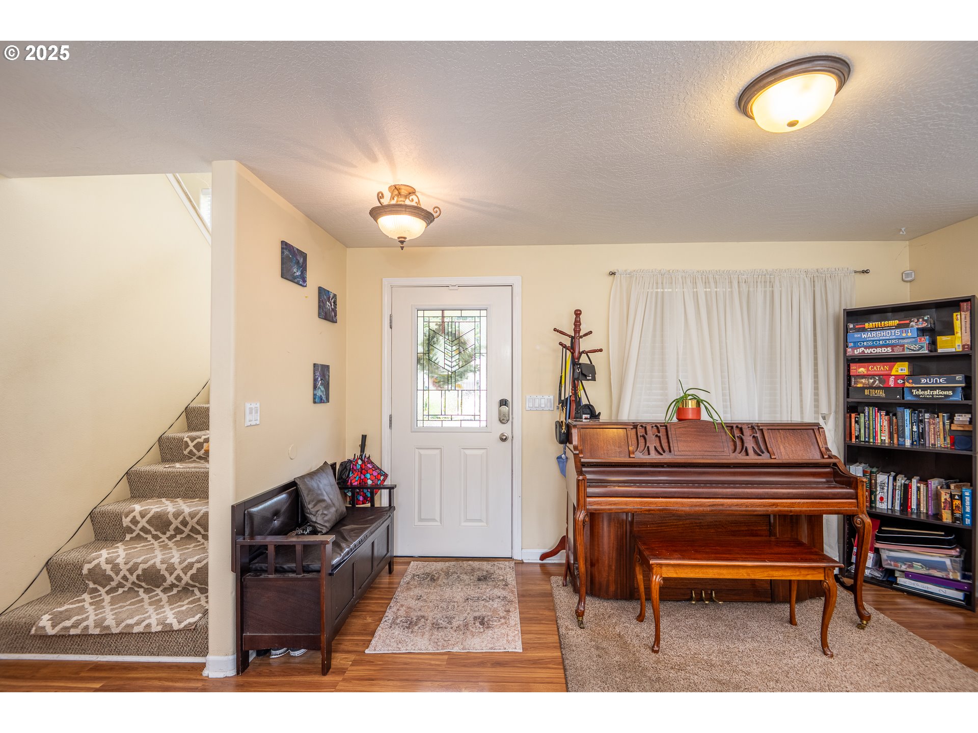 4217 Cole Way Springfield, OR 97478 - Photo 5 of 43 a living room with furniture a piano and a bookshelf