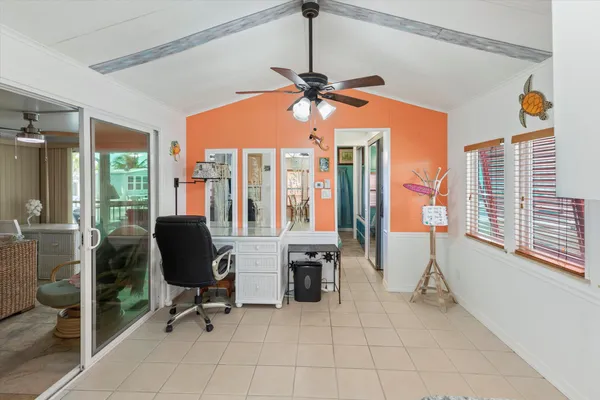 a view of a livingroom with workspace and a window