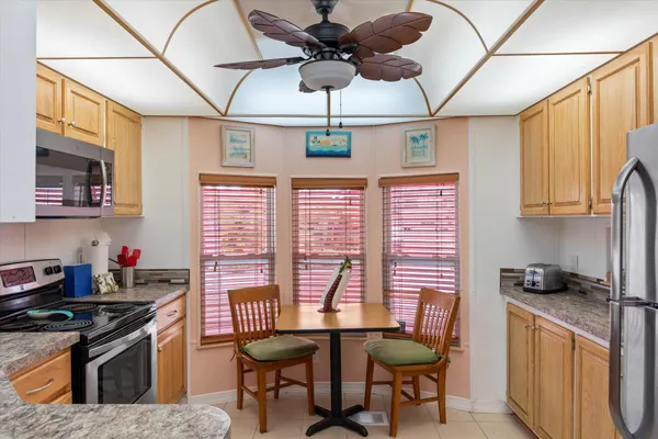 a kitchen with stainless steel appliances granite countertop a stove a sink dishwasher and a refrigerator