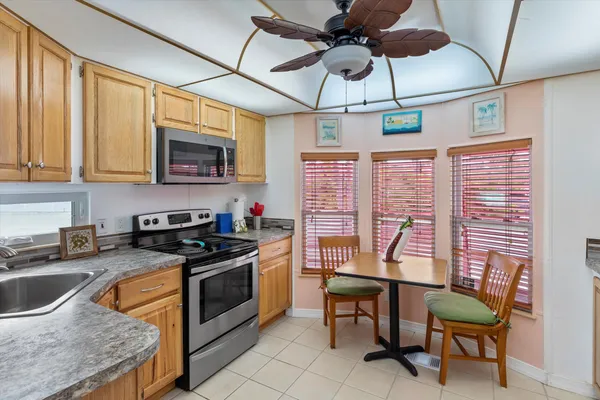 a kitchen with stainless steel appliances granite countertop a stove a sink dishwasher a microwave oven with granite countertops and cabinets