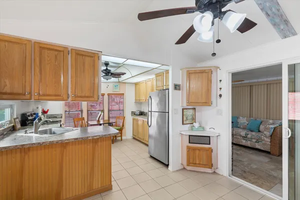 a kitchen with stainless steel appliances granite countertop a refrigerator and a sink