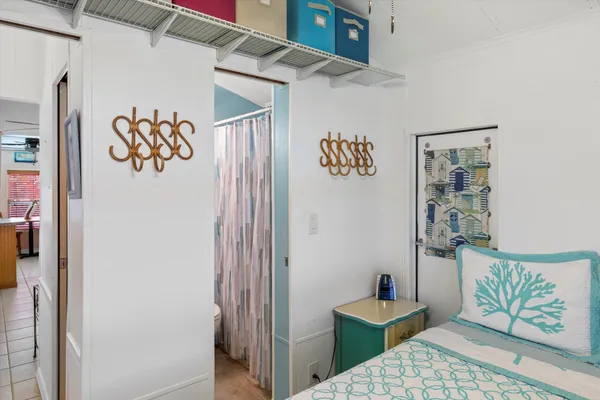 a bedroom with a table and a painting on the wall