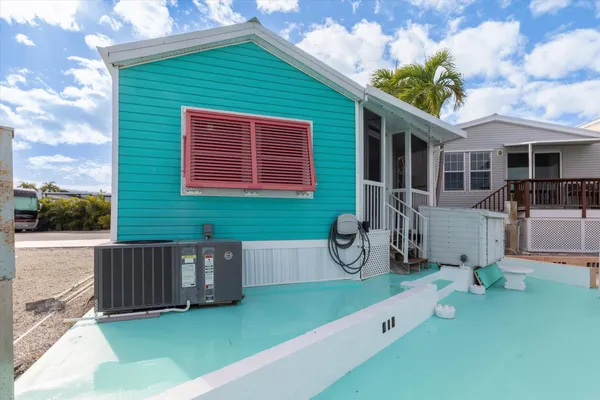 a front view of a house with garden and plants