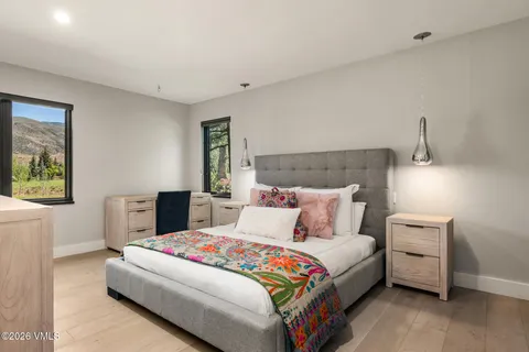 a bedroom with a bed and a lamp on table