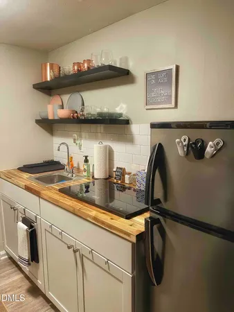 a kitchen with refrigerator and cabinets