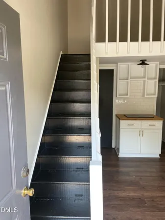 a view of entryway and hall with wooden floor