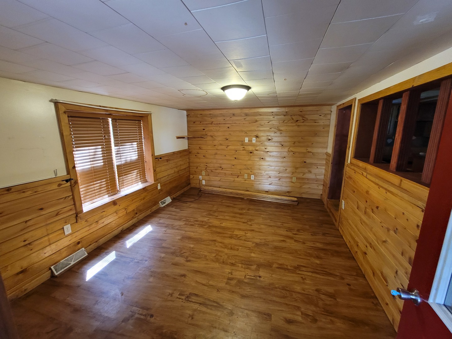 141 Spring Road Dixon, IL 61021 - Photo 3 of 14 a view of an empty room with wooden floor and a window