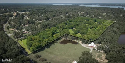 an aerial view of a residential houses covered in trees
