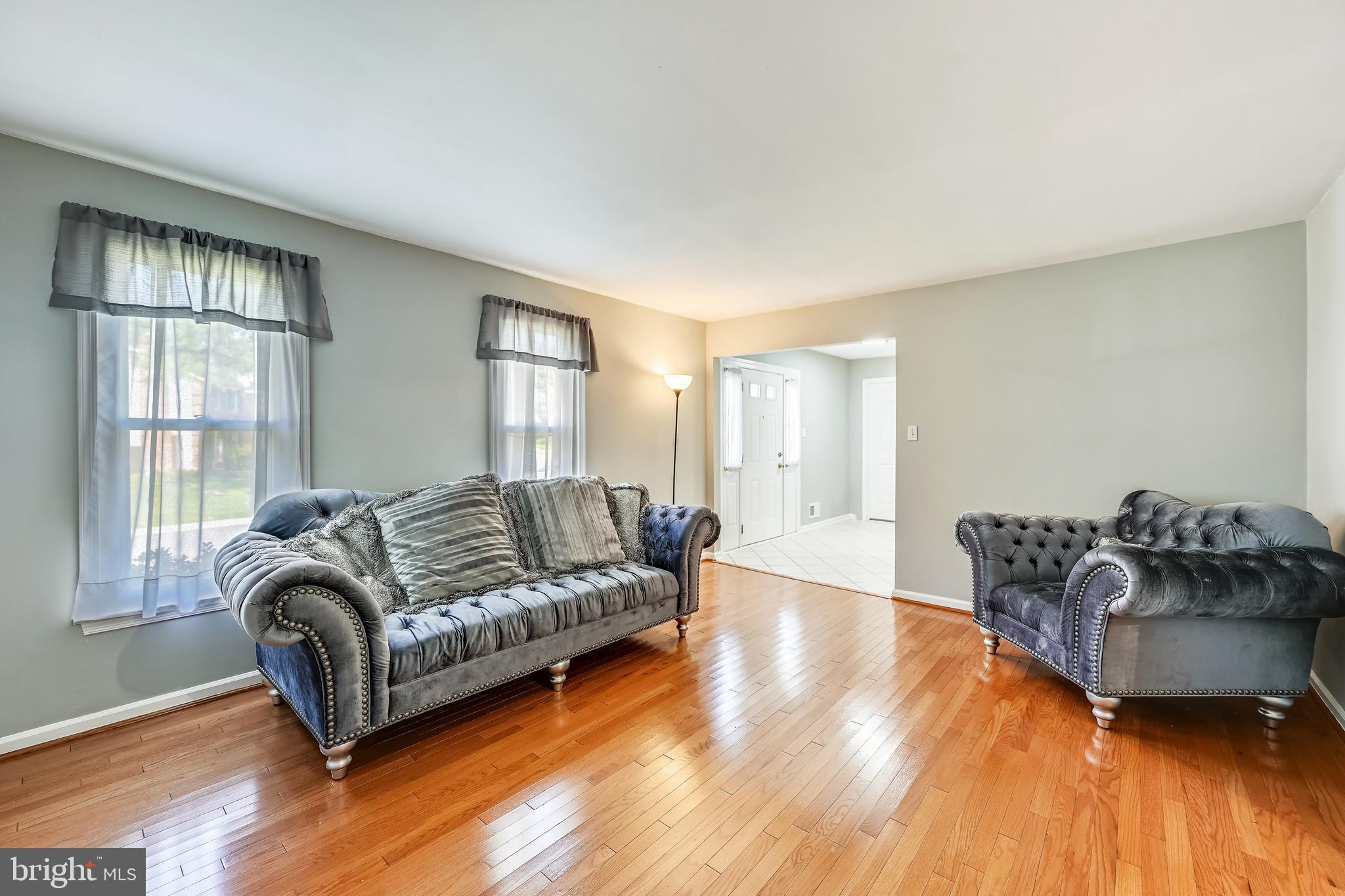 2116 Kings House Road Silver Spring, MD 20905 - Photo 11 of 37 a living room with furniture and a wooden floor